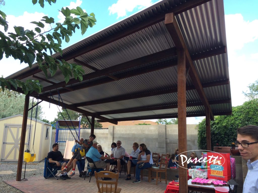 large steel shade structure with swings