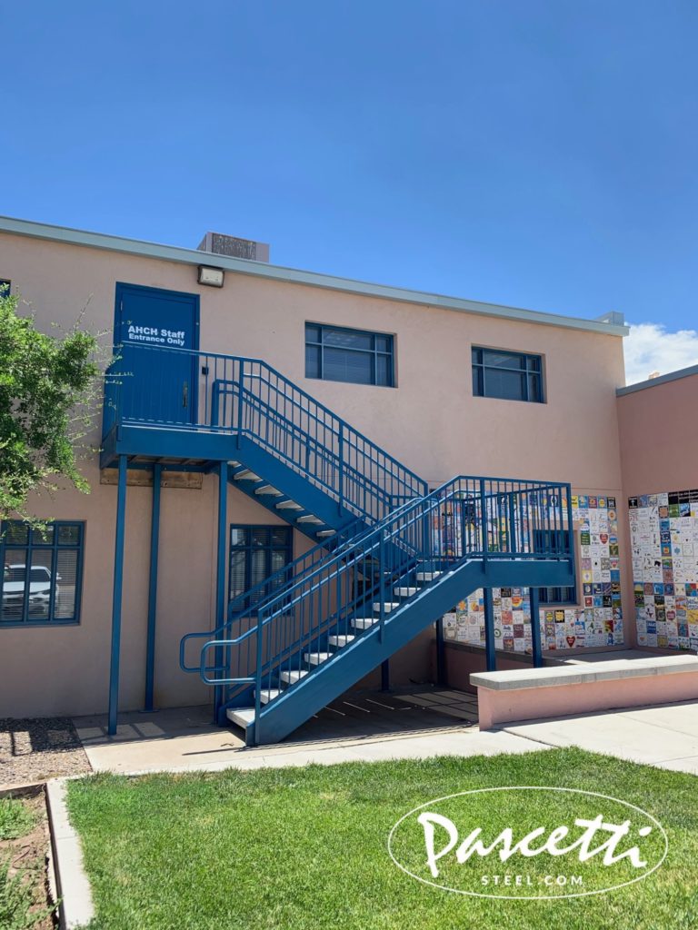 custom commercial steel stair system with integrated railings pre-cast concrete treads and perforated steel stair treads